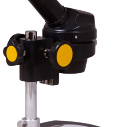 74784_bresser-microscope-national-geographic-20x-monocular_04 Mikroskop edukacyjny z czarnym statywem i żółtymi pokrętłami regulacyjnymi.