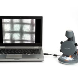 Cyfrowy mikroskop MicroSpin podłączony do laptopa z widocznym obrazem preparatu na ekranie.