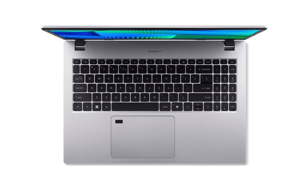 Widok z góry na otwarty srebrny laptop Acer TravelMate z klawiaturą i touchpadem.